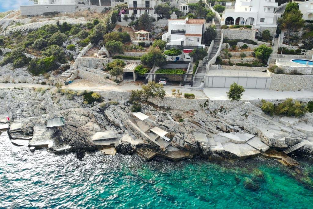 widok z góry na skalisty brzeg z błękitną wodą w obiekcie Family friendly seaside apartments Sevid, Trogir - 14790 w Marinie
