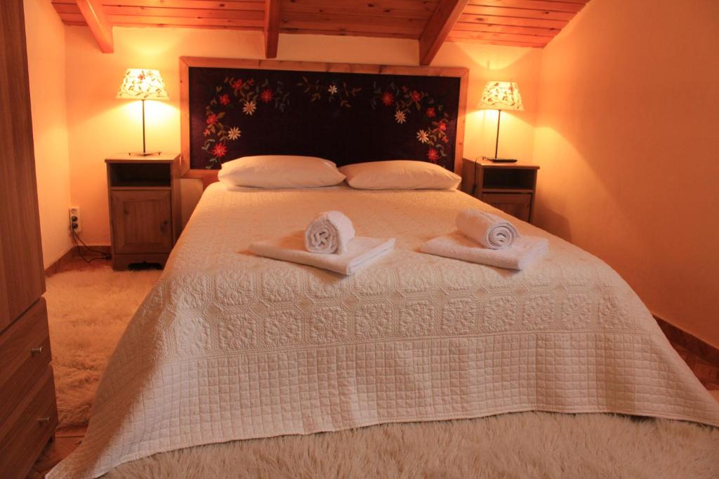 a bedroom with a bed with two towels on it at Patriko in Arachova