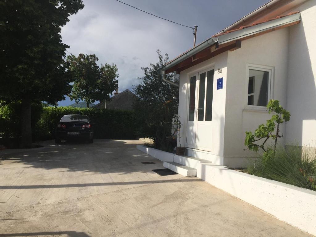 a car parked in a driveway next to a house at Holiday house with a swimming pool Hreljin, Kraljevica - 14813 in Hreljin