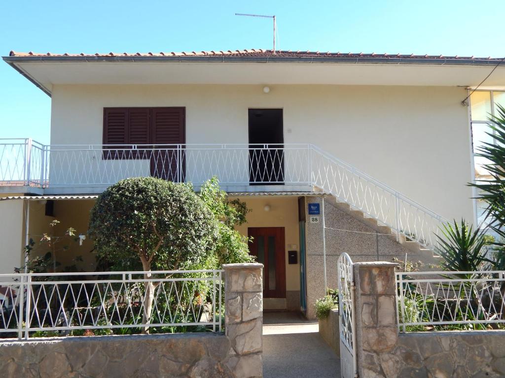 a white house with a staircase in front of it at Rooms with a parking space Stari Grad, Hvar - 14831 in Stari Grad