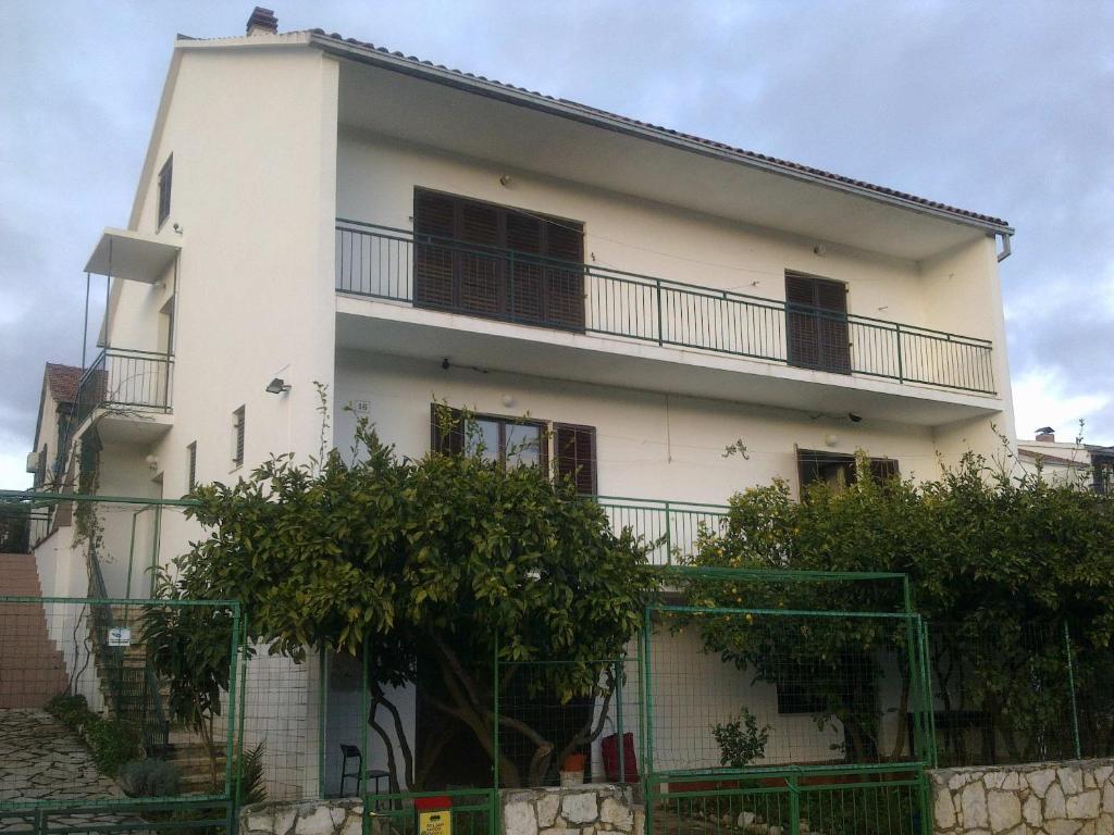 a white house with a balcony on the side of it at Apartments and rooms with parking space Stari Grad, Hvar - 14888 in Stari Grad