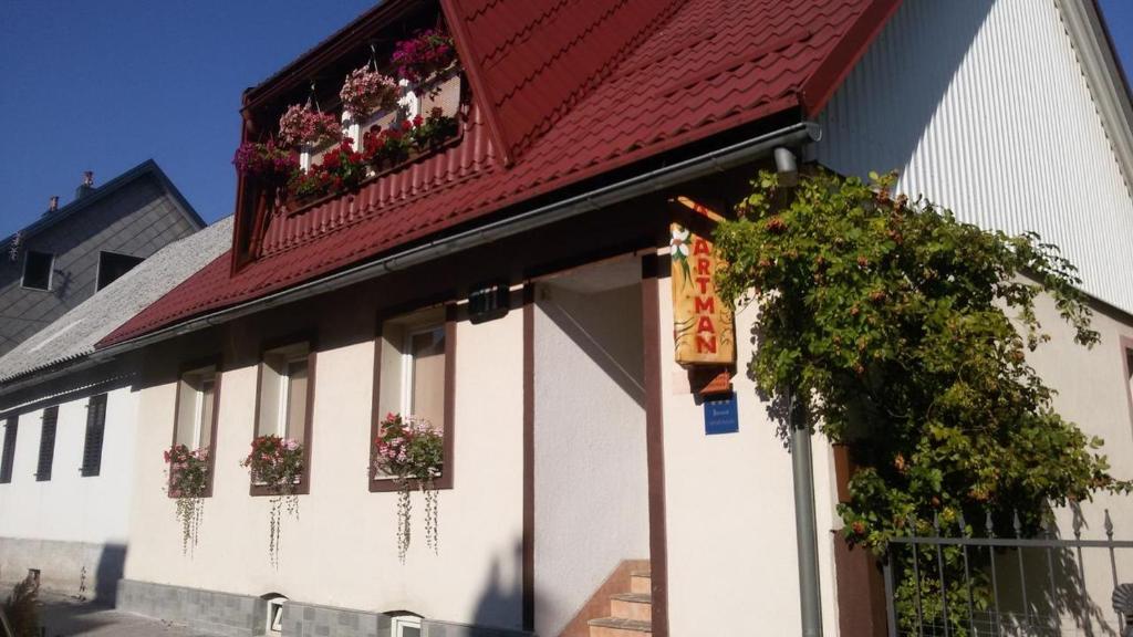 a white building with flower boxes and a red roof at Apartments with a parking space Delnice, Gorski kotar - 14895 in Delnice