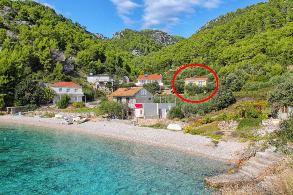 an image of a house on a beach next to the water at Seaside secluded apartments Cove Skozanje, Hvar - 14899 in Gdinj