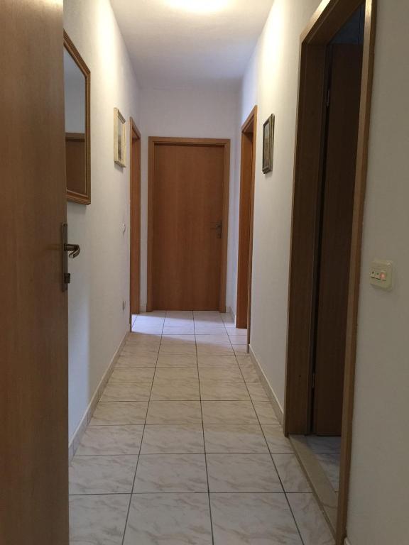 a hallway with a door and a tile floor at Apartments with a parking space Orebic, Peljesac - 15086 in Orebić