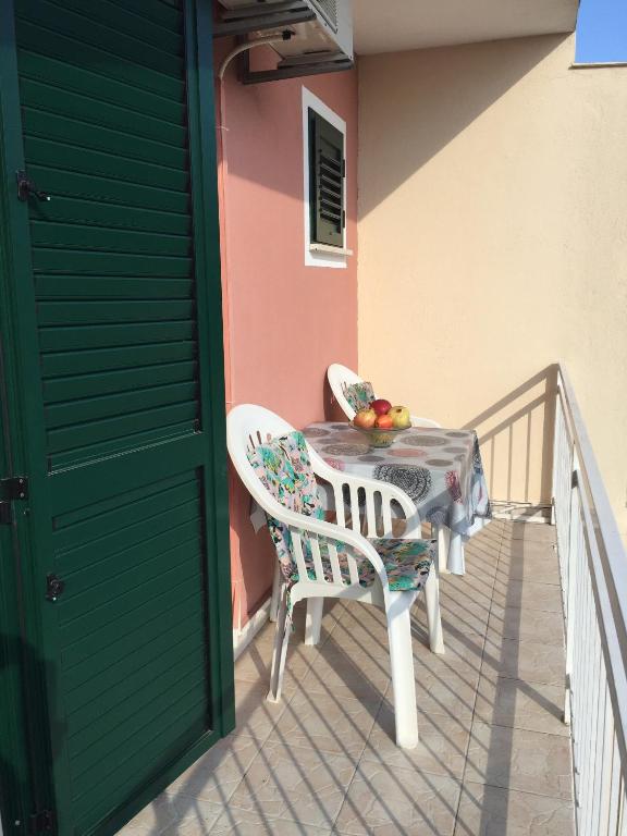 a table and chairs on the balcony of a house at Apartments with a parking space Orebic, Peljesac - 15086 in Orebić