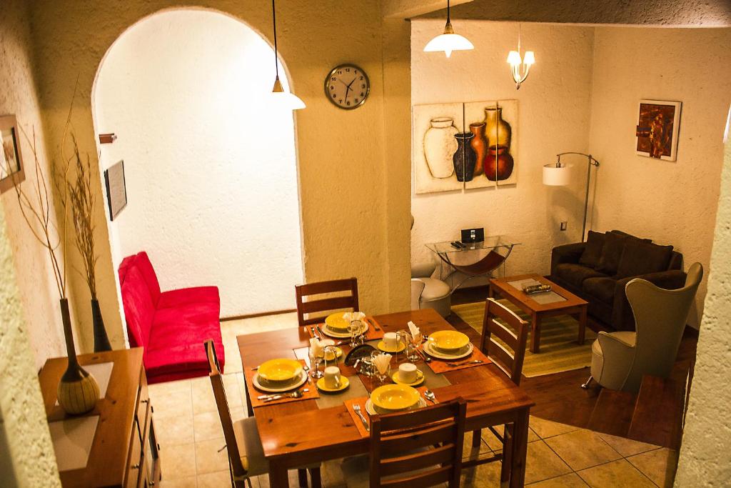 a living room with a table and a dining room at Villas Casa Divina At San Felipe Church Area in Oaxaca City