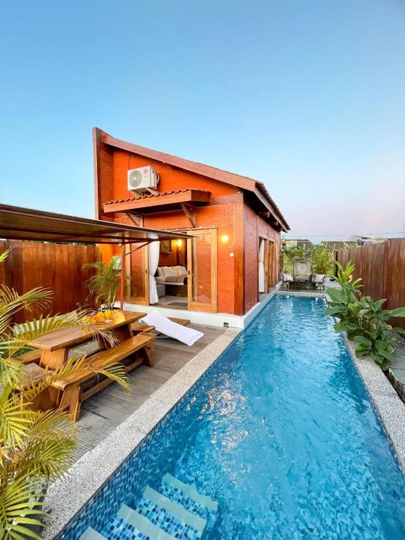 a pool in the backyard of a house at Ginza Bungalow Yogyakarta in Demangan