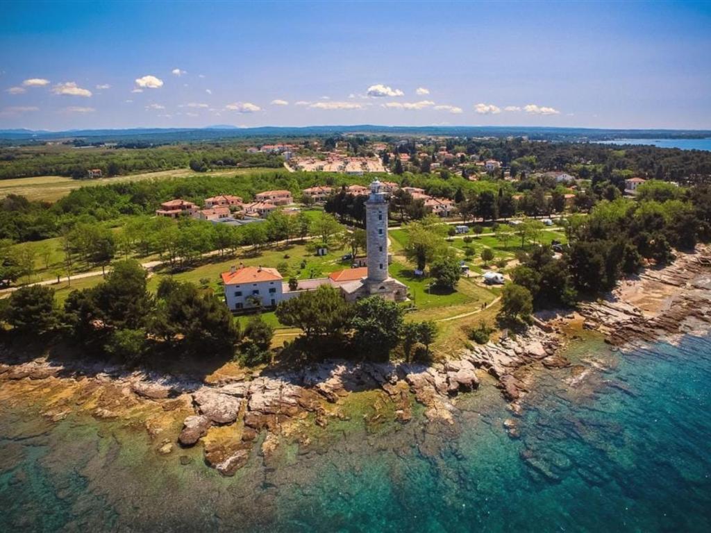 an aerial view of a lighthouse on a island in the water at Holiday Apartment Deluxe in Savudrija