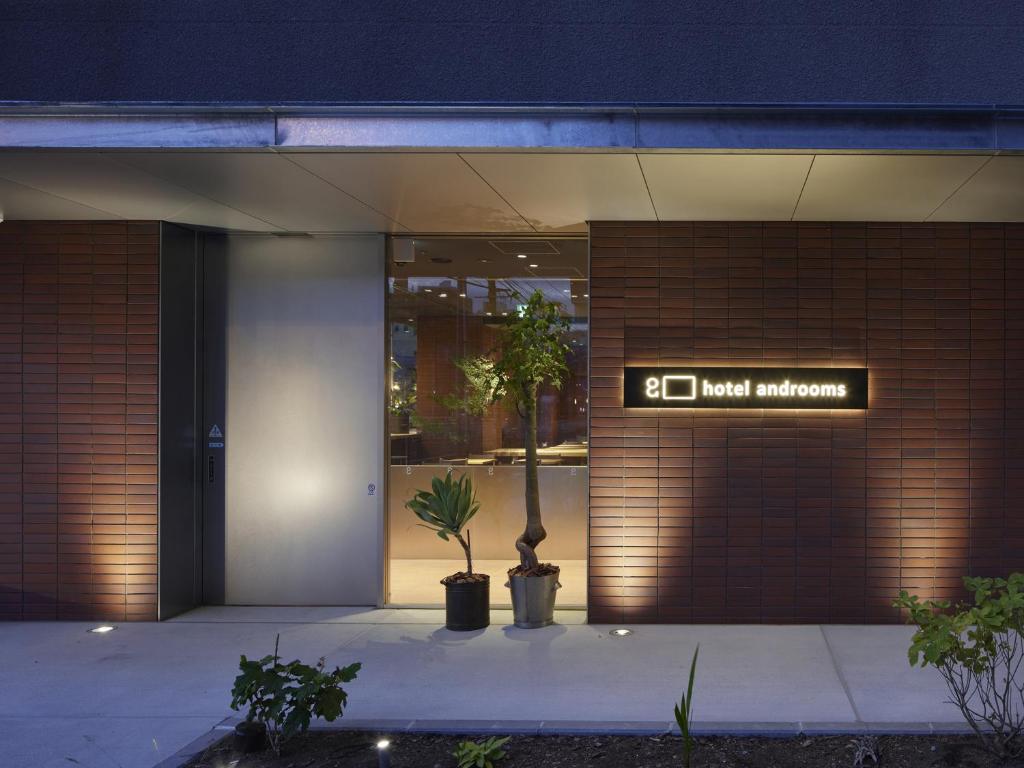 a building with a sign on the side of it at hotel androoms Sapporo Susukino in Sapporo