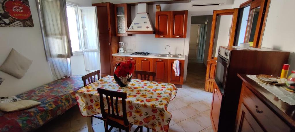 a kitchen with a table with a table cloth on it at Terra è mare in San Teodoro