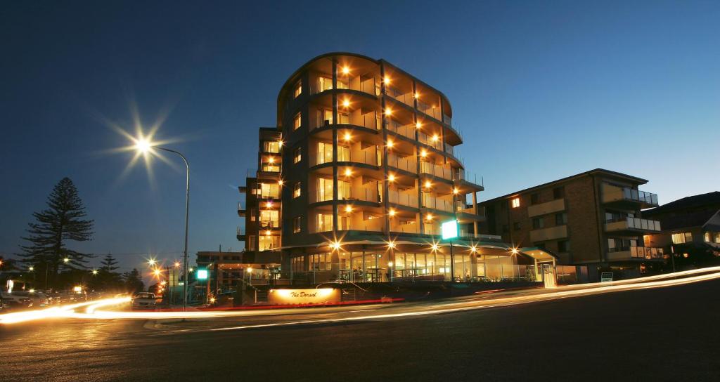 a building at night with lights in front of it at The Dorsal Boutique Hotel in Forster