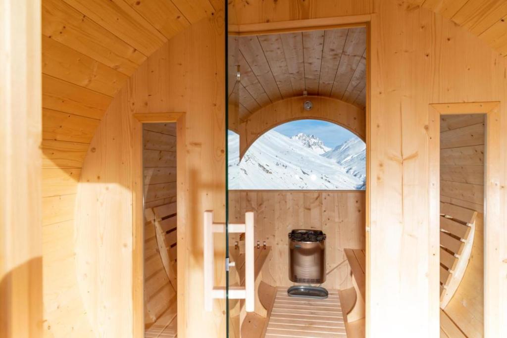 an inside view of a wooden cabin with a window at Pianeta Oro Chalet Allegra in Livigno