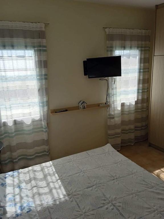 Postel nebo postele na pokoji v ubytování Leros 'Sundown' Guest house