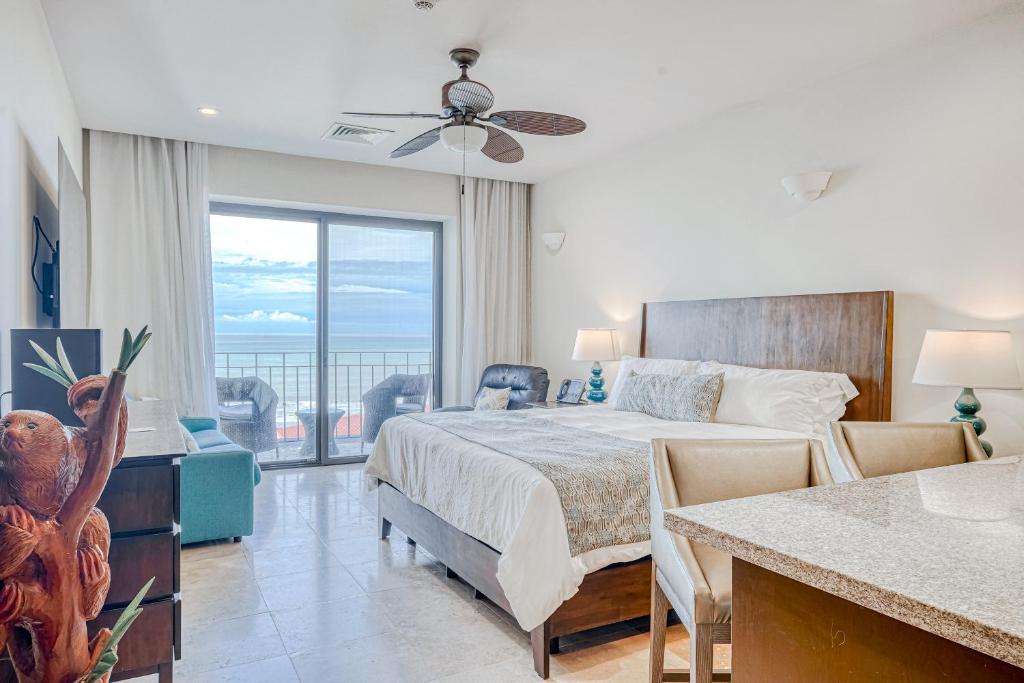 a bedroom with a bed and a view of the ocean at Unit 7701 at Croc's in Jacó