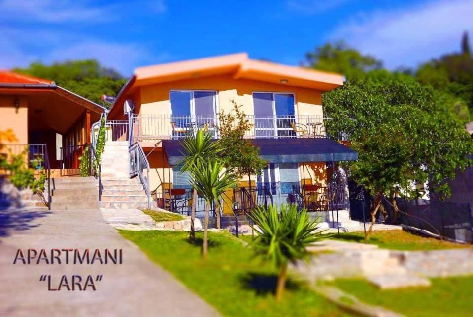 a house with a staircase in front of it at Apartmani La Vi in Bar