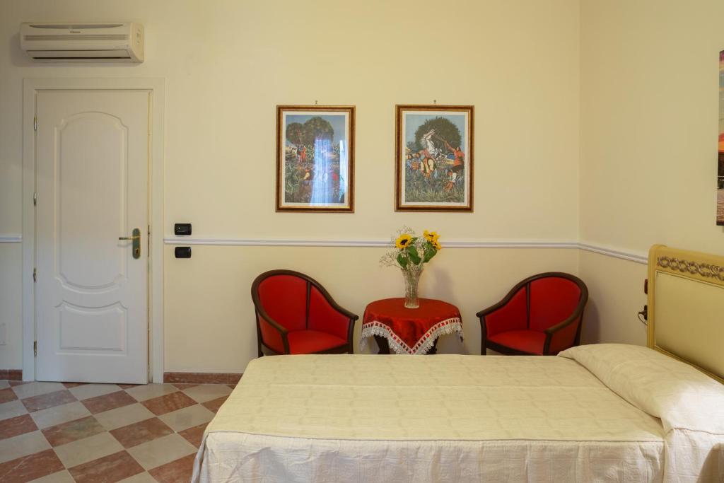 Postel nebo postele na pokoji v ubytování Hotel Trinacria