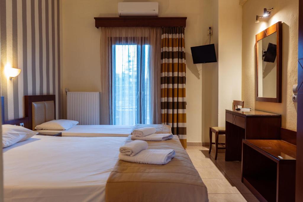 Postel nebo postele na pokoji v ubytování Hotel Zeus