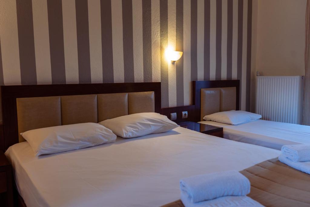 Postel nebo postele na pokoji v ubytování Hotel Zeus
