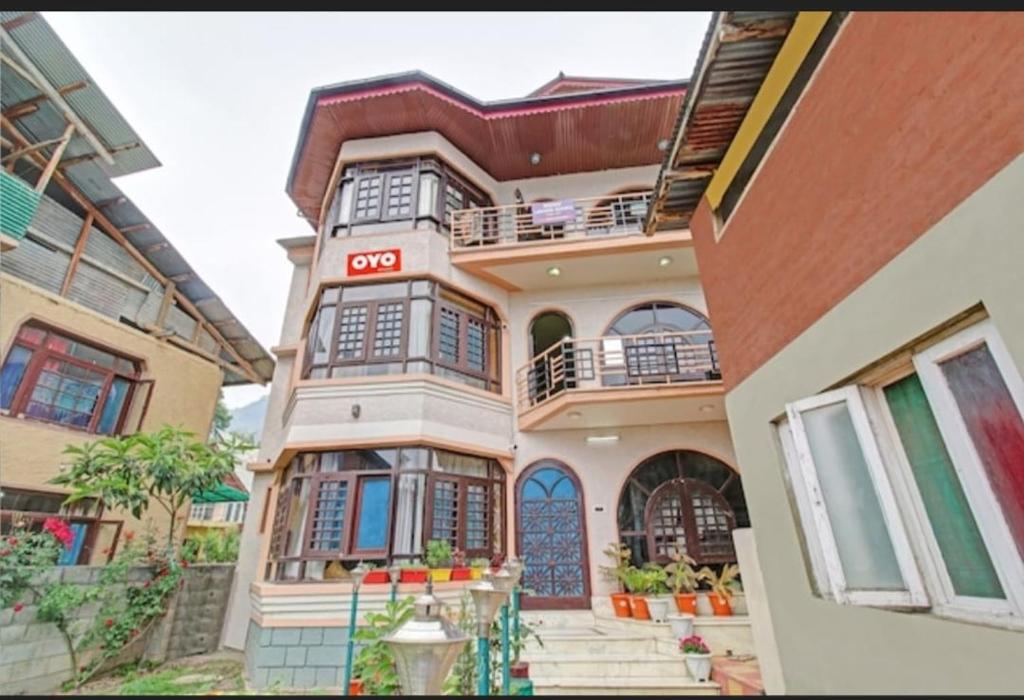 a building with a cota sign on the side of it at Tiramisu Inn By 29bungalow in Srinagar