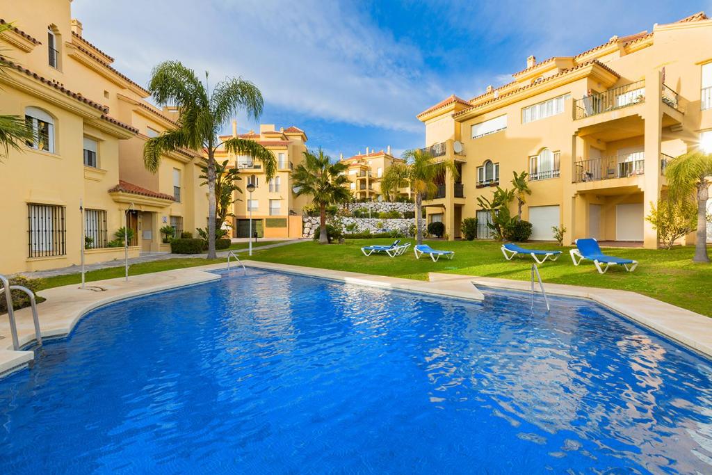 a swimming pool in front of two buildings at Riviera Relax & Pool in Mijas Costa