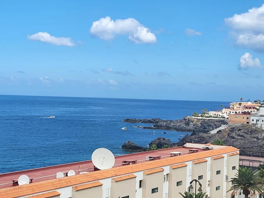 una vista dell'oceano da un edificio di Sunny Holidays in Casa Familiar Playa La Arena a Puerto de Santiago