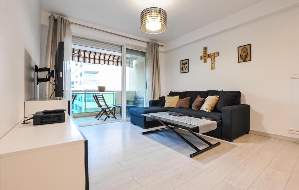 a living room with a couch and a table at Amazing Apartment In Cannes With Wifi in Cannes