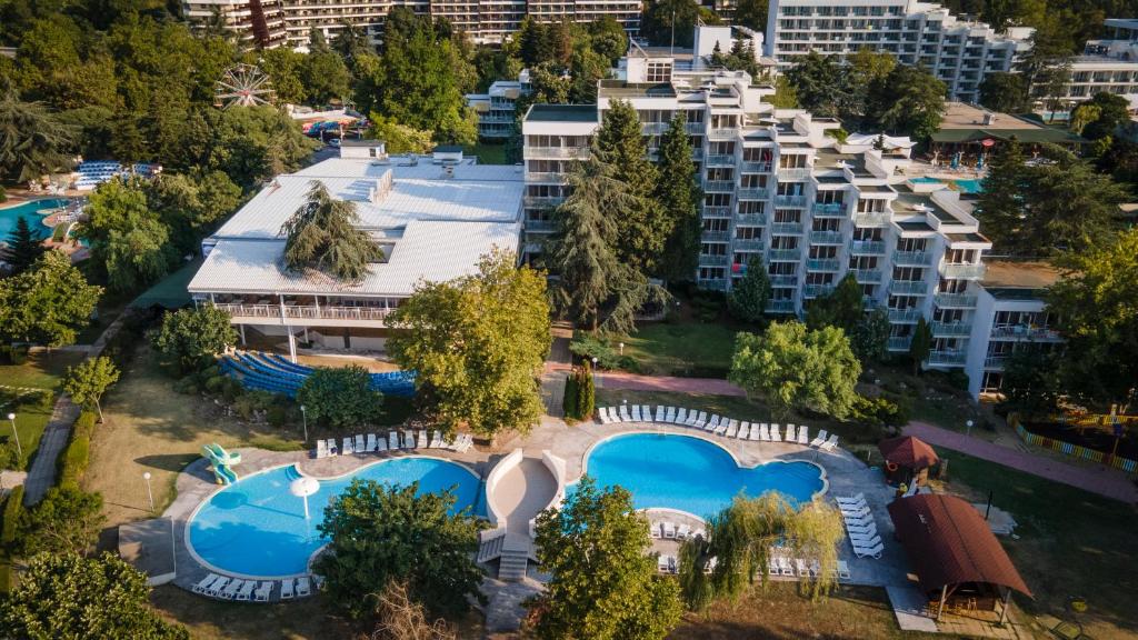 an aerial view of an apartment complex with swimming pools at Hotel Sandy Beach in Albena