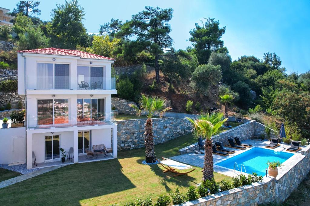 a villa with a swimming pool and a house at Kefi Luxury Villas in Limenas