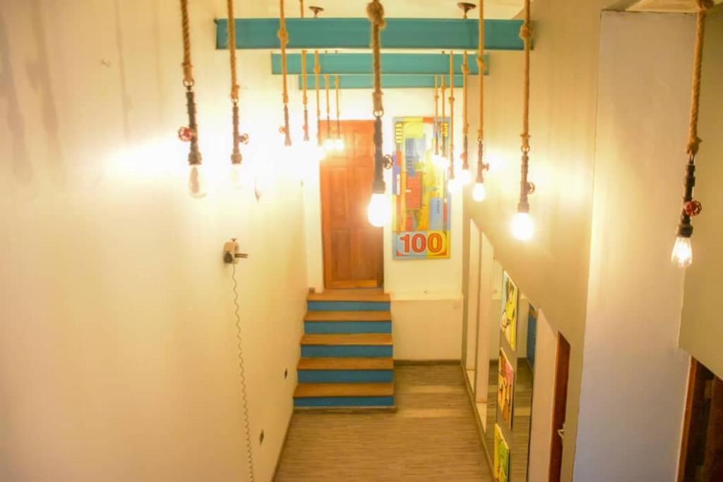 a hallway with a stairway with blue stairs and lights at Lost & Found Zanzibar in Zanzibar City