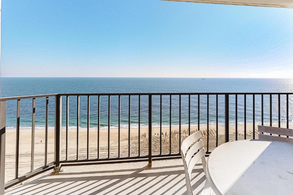 a white chair sitting on a balcony looking at the beach at Plaza 1610 in Ocean City