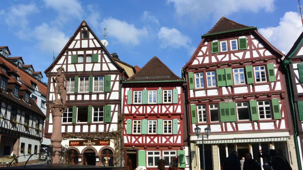 a group of half timbered buildings in a city at Gästehaus am Marktbrunnen in Bretten