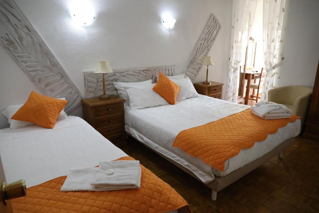 Postel nebo postele na pokoji v ubytování Hotel Aviz
