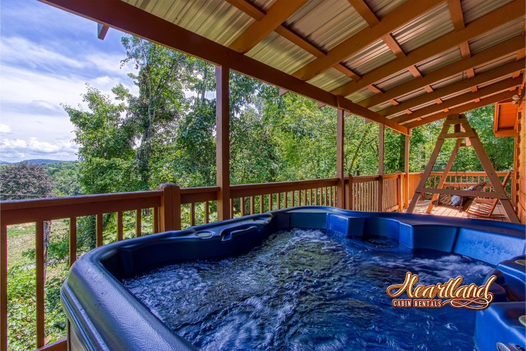 a hot tub on the deck of a house at Country Hideaway in Sevierville