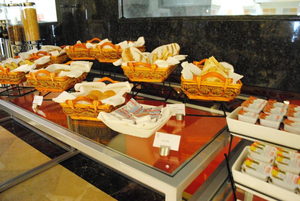 a display case with a bunch of baskets of food at Raviz Center Point Hotel in Dubai