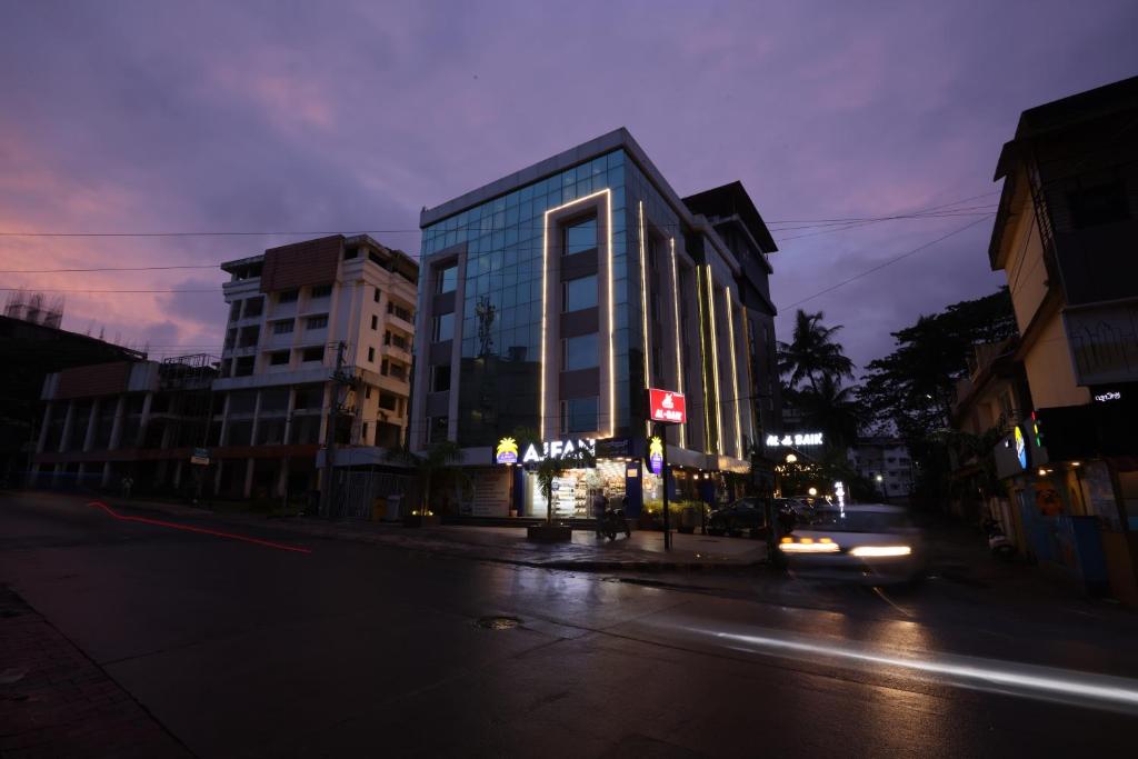a building on a city street at night at Royal Plaza Suites in Mangalore