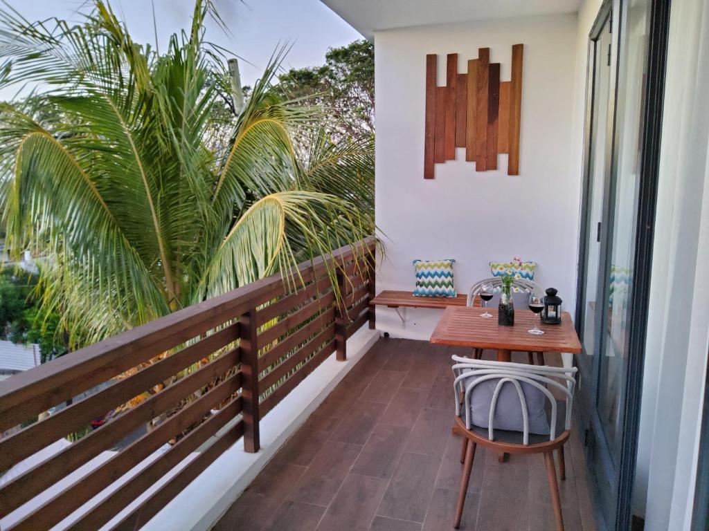 a balcony with a wooden table and chairs at Labrize Studio in La Gaulette