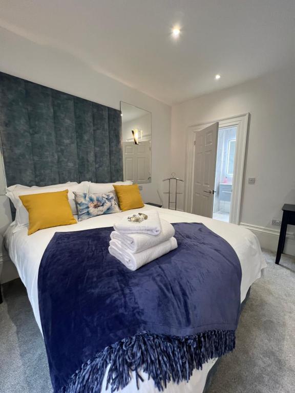 a bedroom with a large bed with towels on it at Winckley Square Residences in Preston