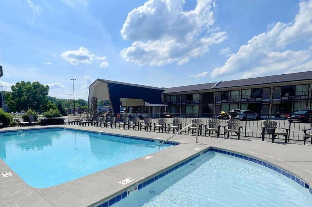 a large swimming pool in front of a building at Travelodge by Wyndham Pigeon Forge Dollywood Lane in Pigeon Forge