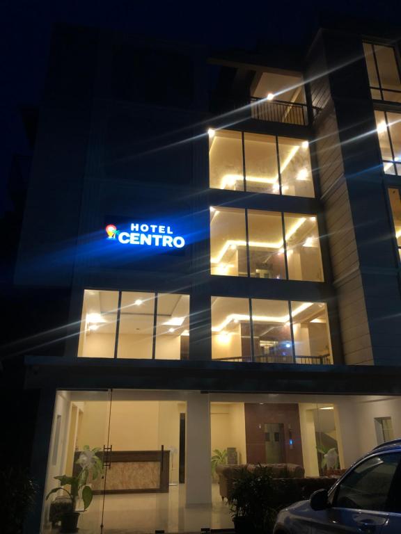 a hotel centrino building at night with a car parked in front at Hotel Centro in Calangute