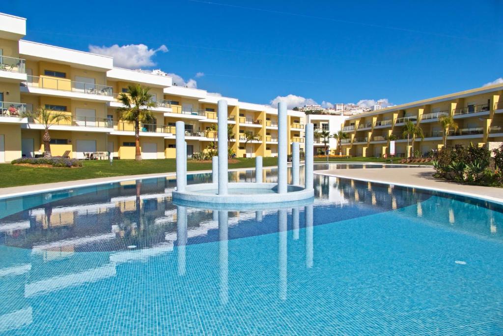 a swimming pool in front of a building at JARDINS DA MARINA APARTMENT Ai in Albufeira
