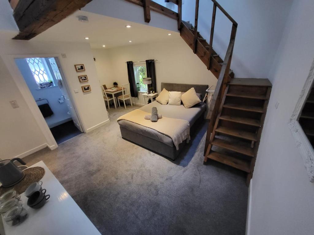 a living room with a bed and a staircase at The Dolphin in Winchester