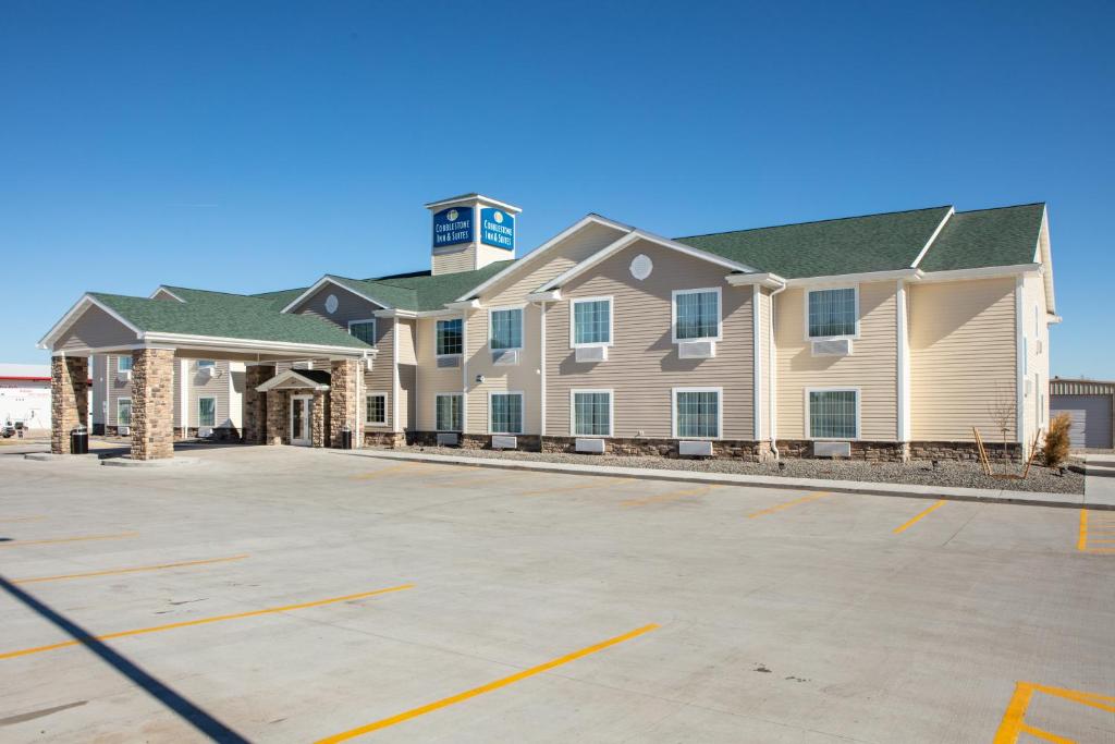 ein großes Apartmenthaus mit Parkplatz in der Unterkunft Cobblestone Inn & Suites - Pine Bluffs 