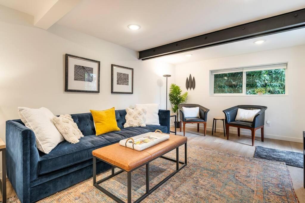 a living room with a blue couch and two chairs at Modern, new & industrial in Georgetown in Seattle