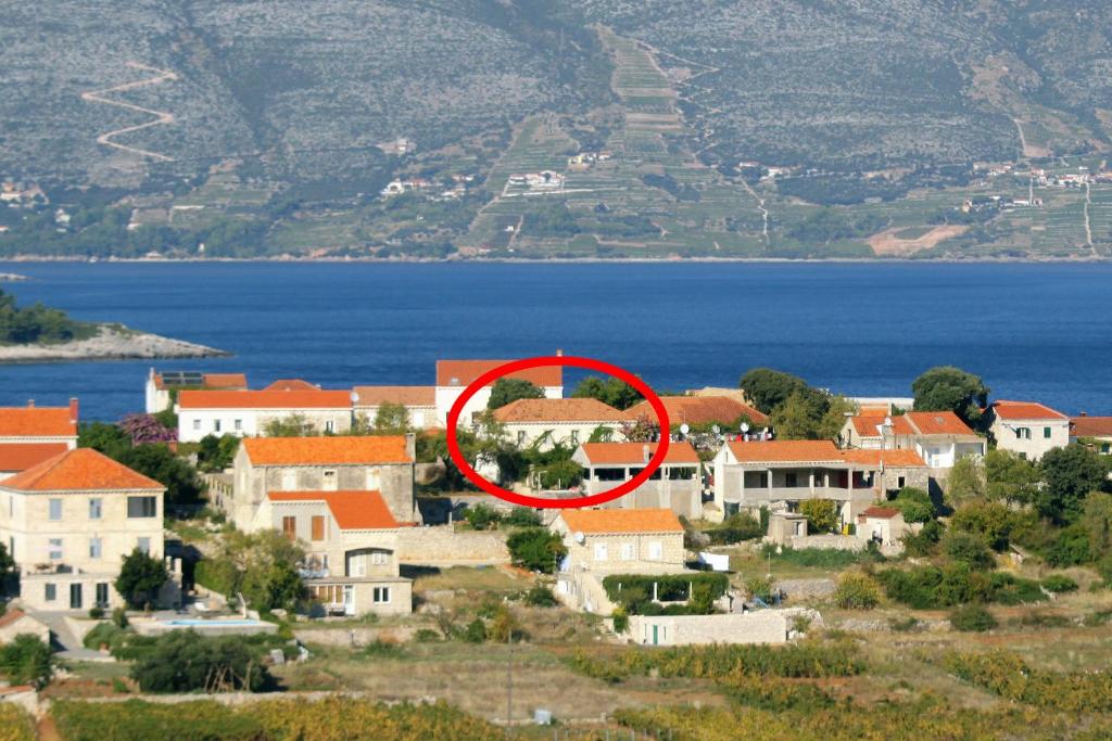 a town with a red circle in front of the water at Apartments with parking space Lumbarda, Korcula - 179 in Lumbarda