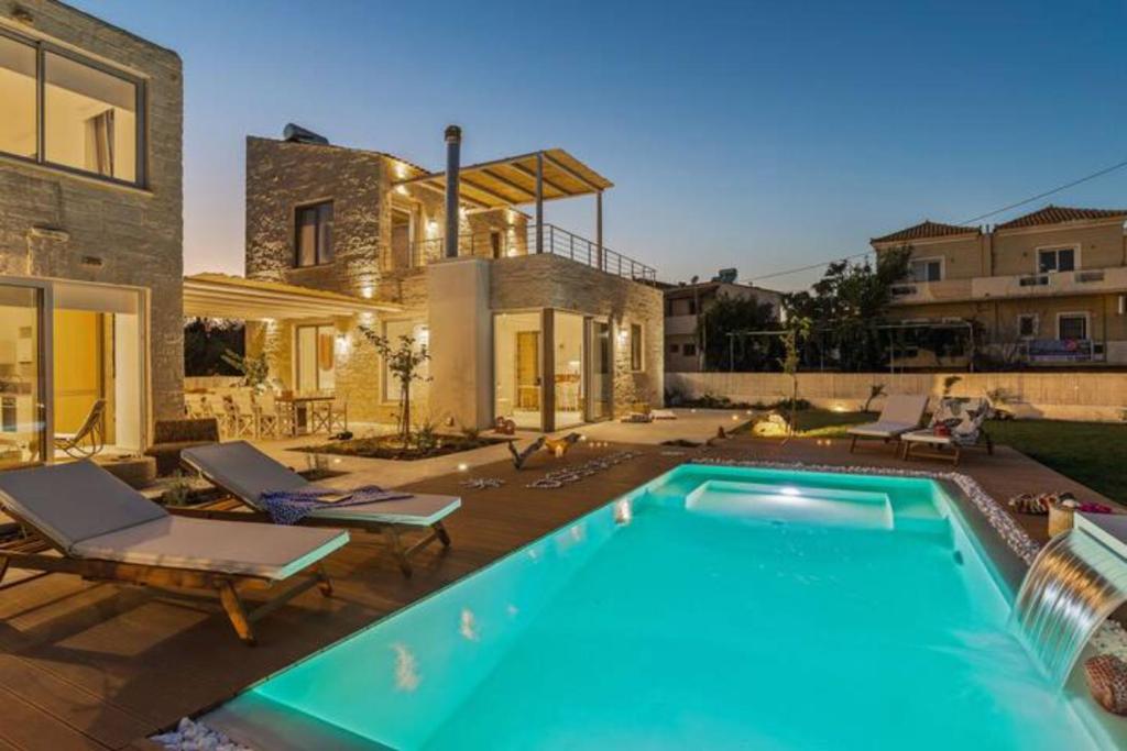 a swimming pool in the backyard of a house at Annassa Suites in Almyrida