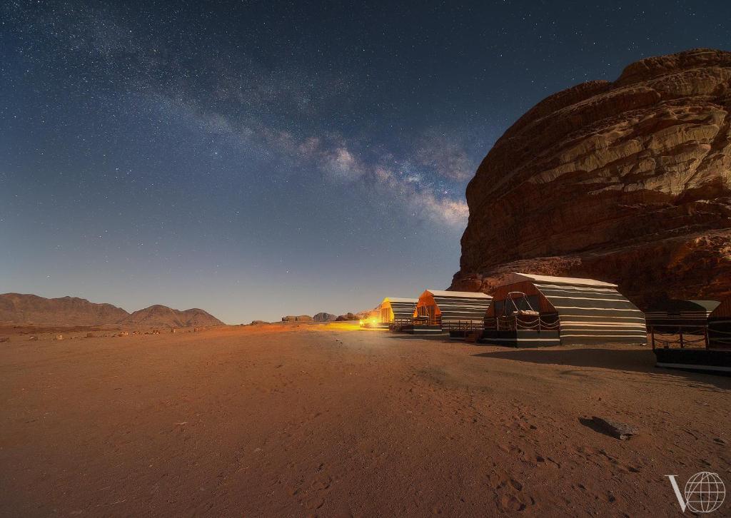 a group of trucks parked in the desert at night at Rum Stars Camp in Wadi Rum