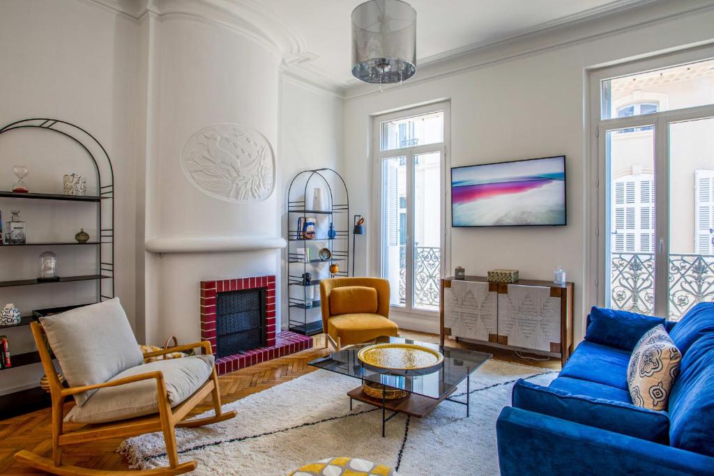 sala de estar con sofá azul y chimenea en Beautiful air conditioned apartment - Marseille - Welkeys en Marsella