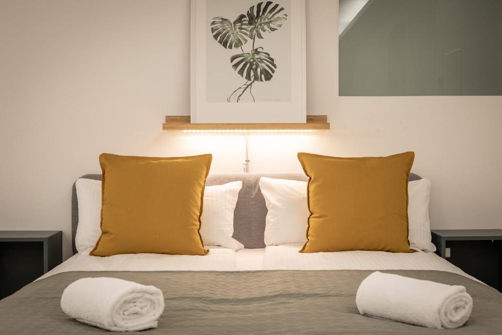 a bedroom with a bed with two pillows at Spacious apartment in Hemholtzkiez Prenzlauer Berg for 8 People in Berlin