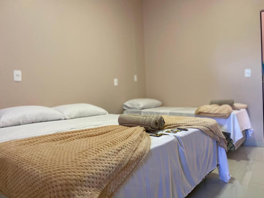 a room with two beds with blankets on them at Pousada Amanhecer no Jalapão in São Félix do Tocantins