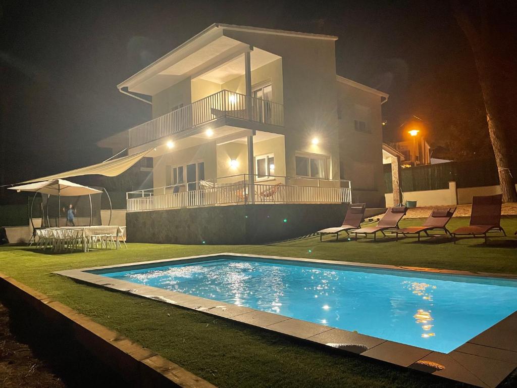 une villa avec une piscine la nuit dans l'établissement Costa Brava Villa, à Platja d'Aro